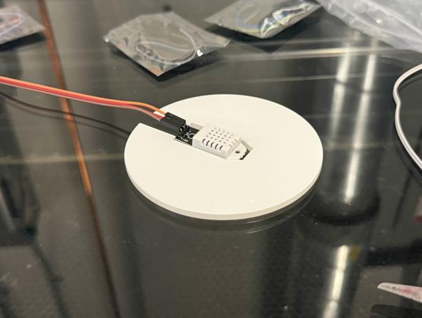 Temperature sensor fitted into a circular acrylic coaster